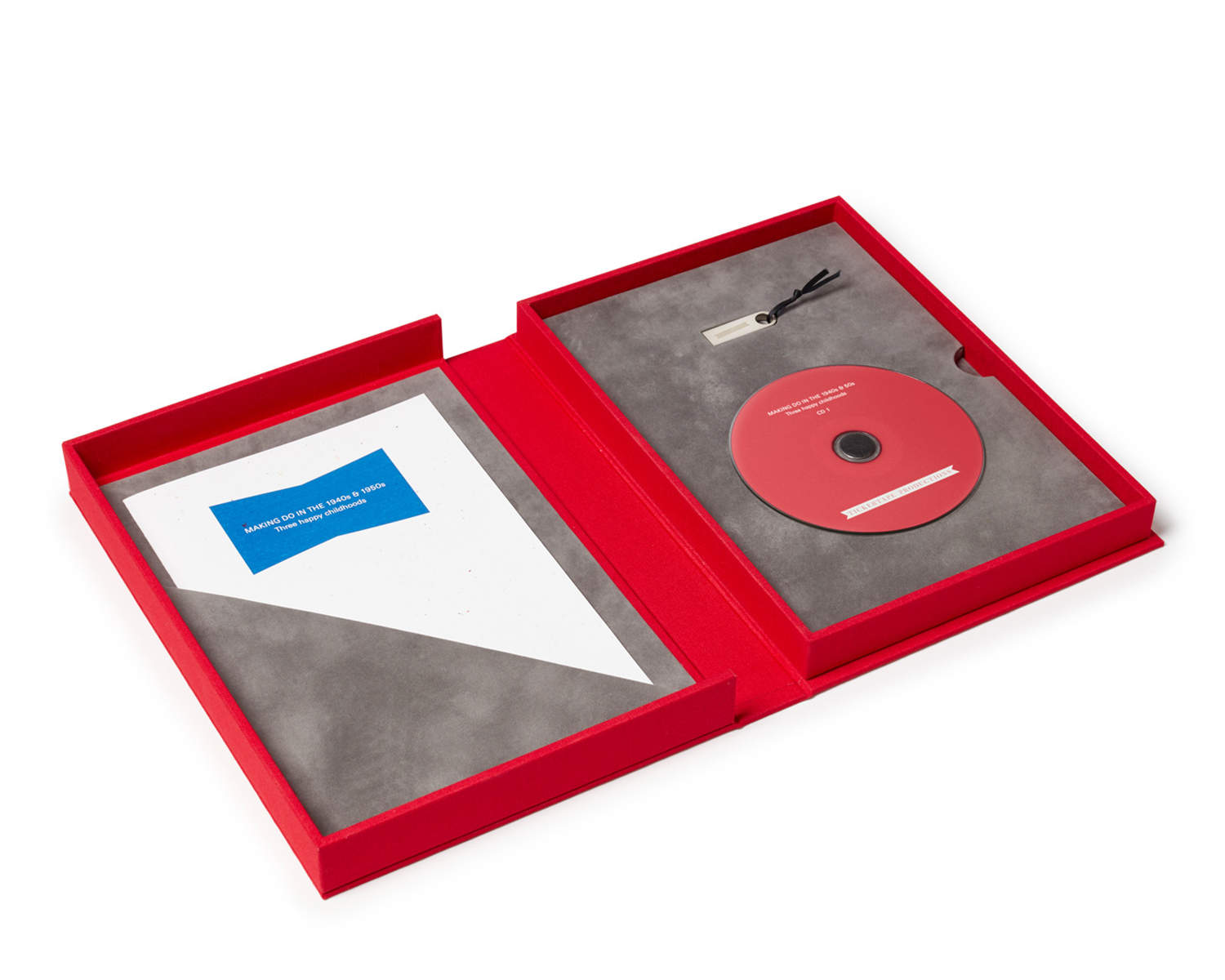 Suedette-lined interior of a Spoken Portrait presentation box: audio CD, USB stick and paper insert with a summary of contents